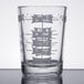 A clear Libbey measuring glass with white numbers on it.