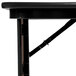 A black Correll adjustable height seminar table with a metal leg.