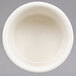 A Hall China ivory swirl souffle dish on a white background.