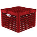 A red plastic Vollrath Traex Plate Crate with 12 compartments and holes.