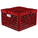A red plastic Vollrath Traex plate rack with 12 compartments and holes.
