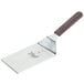 A Mercer Culinary Hell's Handle metal turner with a square edge and wooden handle.