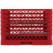 A red plastic Vollrath Traex plate rack with metal rods.