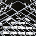 A close up of the metal grid structure of a Vollrath Traex Plate Crate.