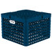 A blue plastic Vollrath Traex Plate Crate with compartments and holes.