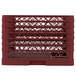 A burgundy plastic Vollrath Plate Crate with 9 compartments.