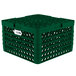 A green plastic Vollrath Traex Plate Crate with 12 compartments.