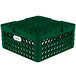 A green plastic Vollrath Traex Plate Crate with compartments and holes.
