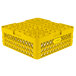 A yellow plastic Vollrath Traex Plate Crate with 38 compartments and holes.
