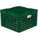 A green plastic Vollrath Traex plate rack with 21 compartments and holes.