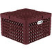 A burgundy plastic Vollrath Traex plate rack with 21 compartments and a white label.