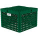 A green plastic Vollrath Traex Plate Crate with holes.