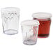 A group of clear plastic Dinex Fenwick tumblers with clear lids and straws.