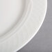 A close-up of a Homer Laughlin Kensington Ameriwhite bright white china plate with a circular design.