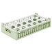 A white and green plastic Vollrath glass rack trim divider with four compartments.