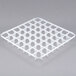A white plastic Vollrath glass rack divider with holes in it.