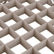 A close up of a beige plastic grid with squares.