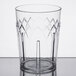 A clear Dinex plastic tumbler with a design on it.