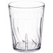 A clear Dinex plastic tumbler with a wavy design.
