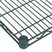 A Metro Super Erecta wire shelf with smoked glass on a table.