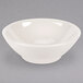 A white Homer Laughlin China cereal bowl with a small rim on a gray surface.