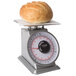 A loaf of bread on a Taylor Heavy Duty mechanical portion scale.