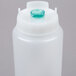A white plastic bottle with a green cap and thin dispensing valve.