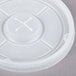 A close-up of a white plastic lid with a cross.