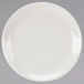 A Homer Laughlin ivory coupe china plate with a white rim on a gray surface.