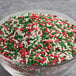 A bowl of Christmas Sprinkles on a table.
