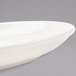 A close-up of a Homer Laughlin ivory china platter with a curved edge.