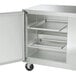 A stainless steel Traulsen undercounter freezer with two open doors.