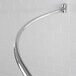 A Crescent curved shower rod with bright finish.