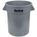 A gray plastic Continental Huskee trash can with handles.