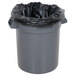 A grey Continental Huskee 20 gallon round trash can with a black plastic bag.