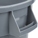 A gray plastic Continental Huskee trash can with a handle.
