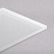 A white rectangular Eastern Tabletop tempered glass shelf on a gray surface.