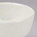 A Tuxton eggshell china bowl with a rolled edge.