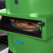 A green TurboChef Fire countertop pizza oven with a pizza inside.