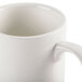 A close up of a CAC Ivory Prime stackable China mug with a handle.