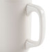 A close-up of a CAC Ivory china mug with a handle.