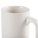 A close up of a white CAC china mug with a handle.