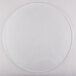 A clear circle on a white surface with a white plate on it.