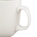 A close-up of a CAC Camptown ivory china mug with a handle.