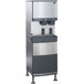 A white Follett 50 Series water cooled freestanding ice and water dispenser with two dispensers.