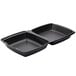 A Dart black foam square takeout container with two compartments on a counter.