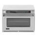 An Amana heavy duty commercial steamer microwave oven with a glass door and digital display.