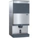 A silver and black Follett countertop ice machine with a water dispenser.