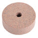 A circular sharpening stone with a hole in the center.