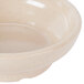 A sandstone bowl with a white rim.